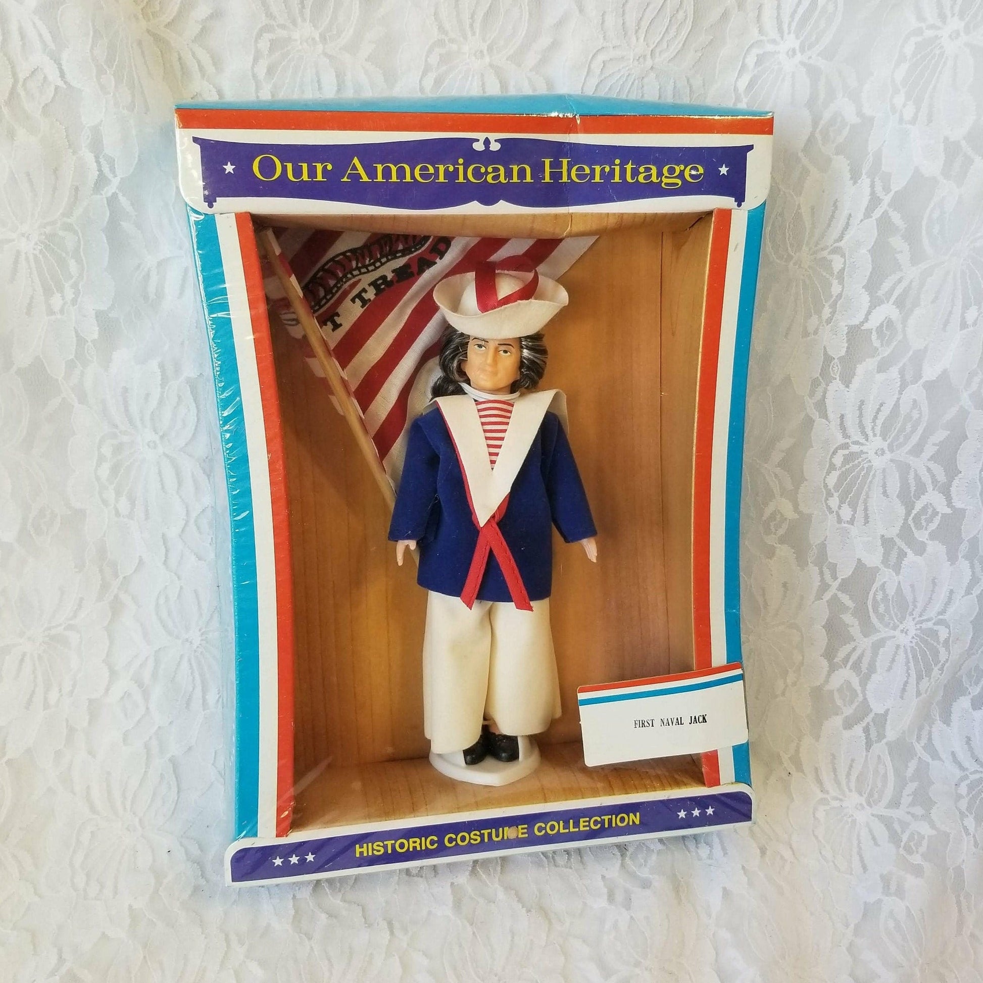 This is a NEW in BOX doll from 1976, nobody has ever taken him out of the box! He is in excellent condition.  A wonderful collector's item or a gift for a veteran in your family.  Excellent condition comes with a flag included.   The First Navy Jack (flag) is the current naval jack of the United States, authorized by the U.S. Navy, and is flown from the jackstaff of commissioned vessels of the U.S. Navy while moored pier-side or at anchor. 