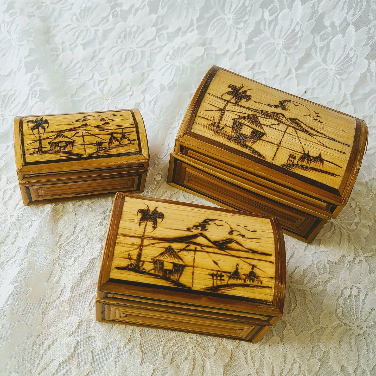 This is a set of 3 boxes that nest inside of one another.  Vintage Hand Painted Indonesian Nesting Bamboo Boxes ~ Intricate Wood Burning Design Featuring an Indonesian Island Fishing Village with Grass Huts, Palm Trees, Fish Racks, Seagulls, and a Beautiful Island Sunset~ Red Velvet Inside